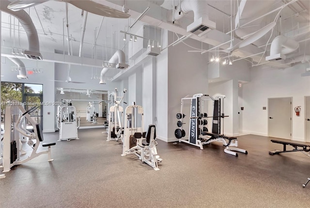 exercise room with a high ceiling