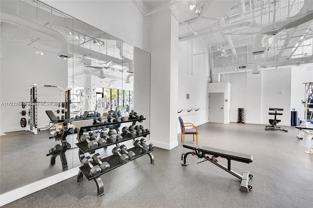 gym with a towering ceiling