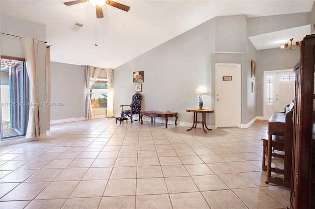 interior space featuring ceiling fan, light tile patterned floors, and lofted ceiling