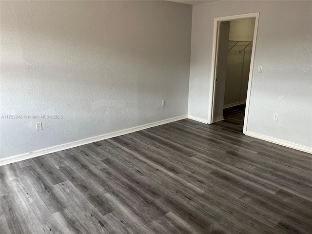 empty room featuring dark hardwood / wood-style flooring