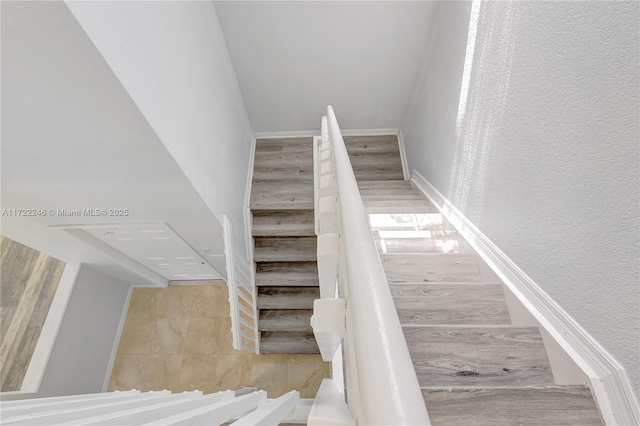 stairs featuring wood-type flooring