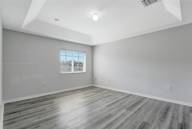 unfurnished bedroom featuring a closet and dark wood-type flooring