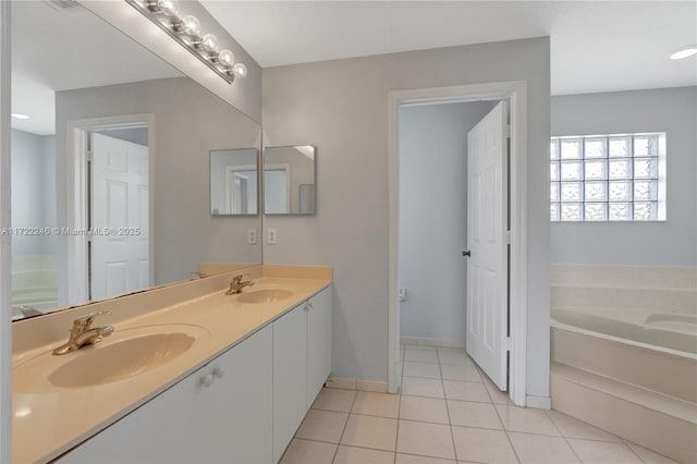 bathroom with tile patterned flooring, vanity, and a tub to relax in