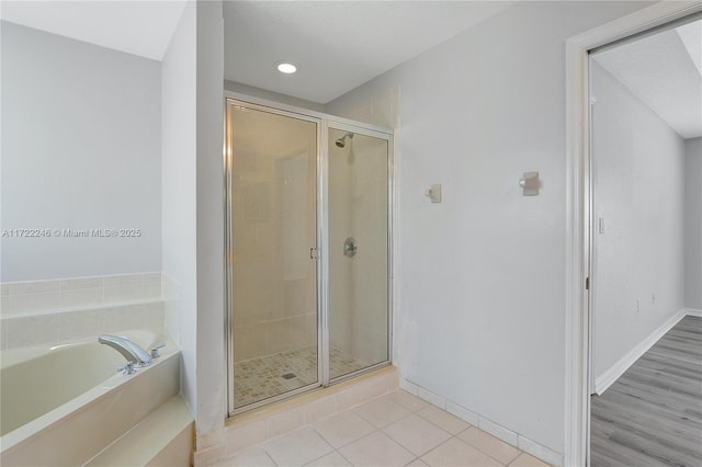 bathroom featuring shower with separate bathtub and tile patterned flooring