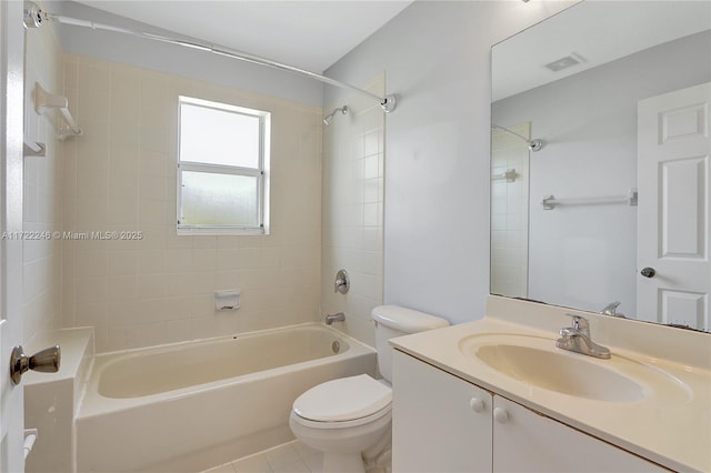 full bathroom with vanity, tile patterned flooring, tiled shower / bath combo, and toilet