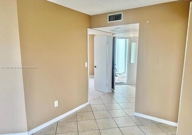 empty room featuring light tile patterned floors