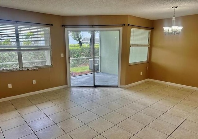 doorway to outside featuring a textured ceiling, a notable chandelier, and light tile patterned flooring