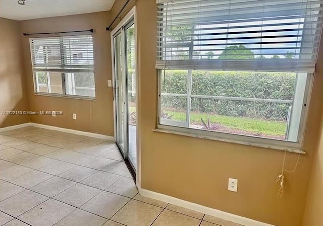 doorway with light tile patterned flooring