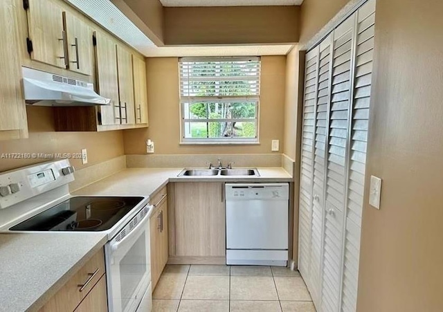 kitchen featuring light tile patterned flooring, white appliances, sink, and light brown cabinets