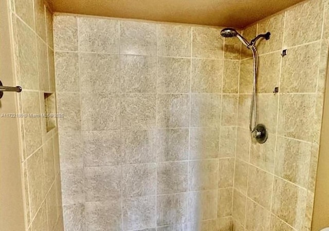 bathroom with a tile shower