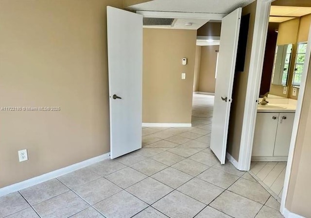 interior space with sink and light tile patterned flooring