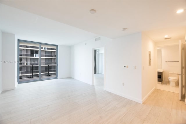 unfurnished room featuring light hardwood / wood-style floors