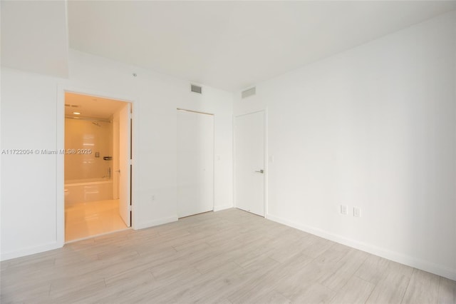 spare room featuring light hardwood / wood-style floors