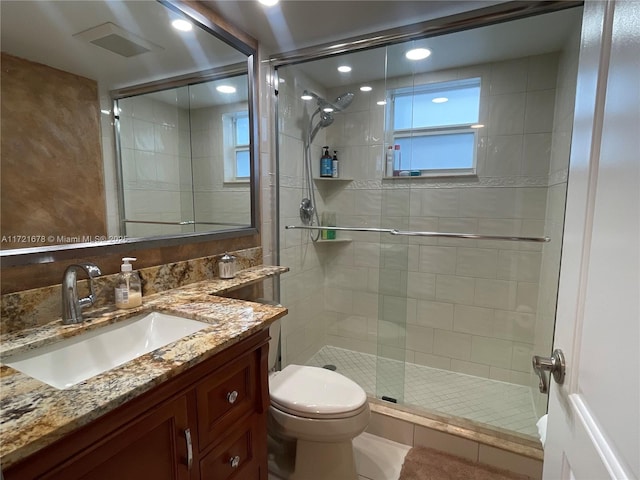 bathroom with tile patterned flooring, vanity, toilet, and walk in shower