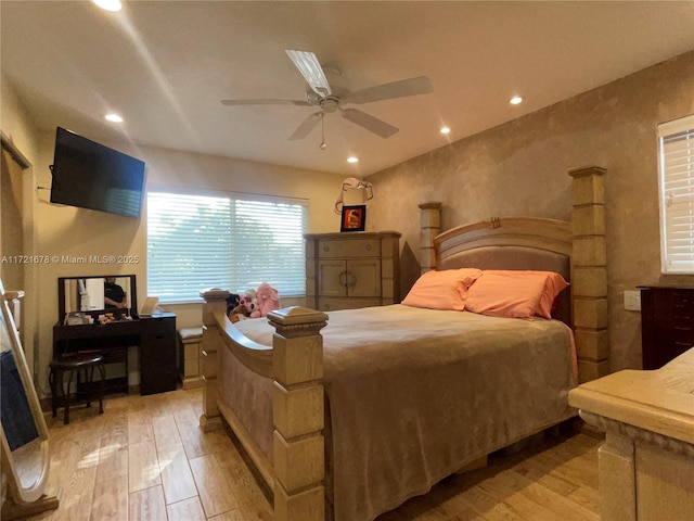 bedroom with ceiling fan and light wood-type flooring