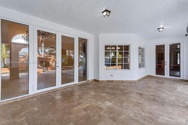 unfurnished sunroom featuring french doors