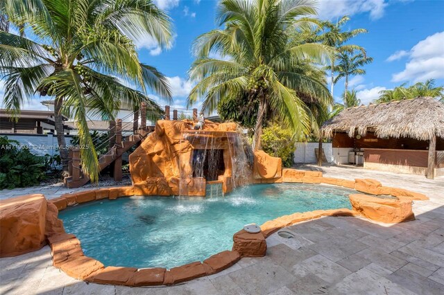 view of swimming pool with pool water feature