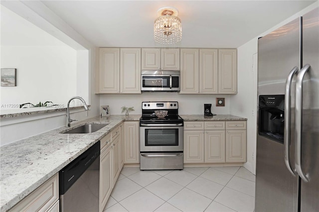 kitchen featuring a chandelier, sink, appliances with stainless steel finishes, and cream cabinets