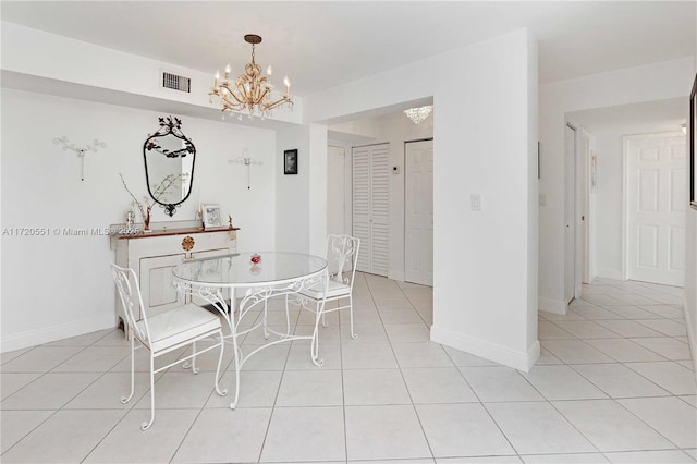 tiled dining room featuring a notable chandelier