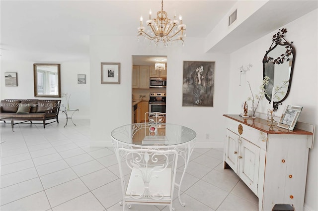 tiled dining space with a chandelier