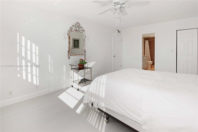 bedroom with a closet, ensuite bathroom, and ceiling fan