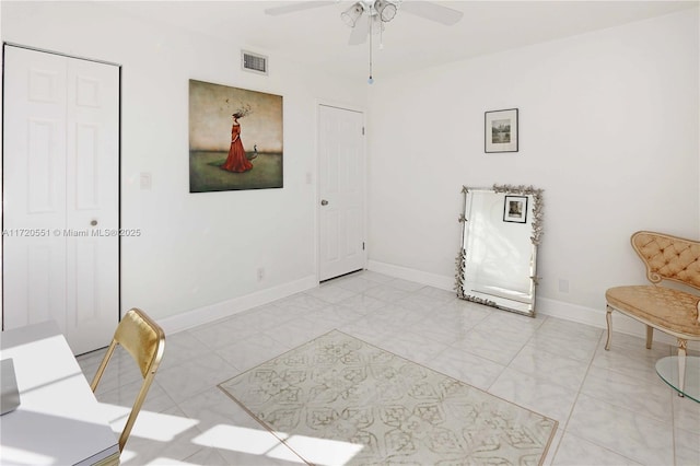 sitting room featuring ceiling fan