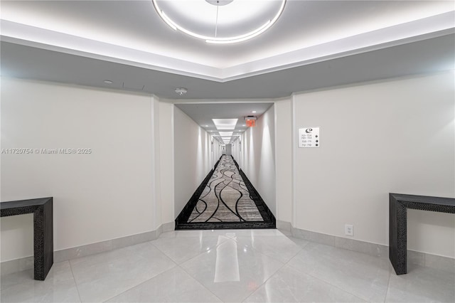 interior space featuring baseboards and tile patterned flooring