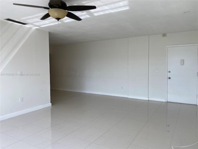 tiled spare room featuring ceiling fan