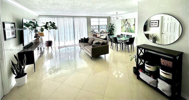 living room with a textured ceiling, light tile patterned floors, crown molding, and a chandelier