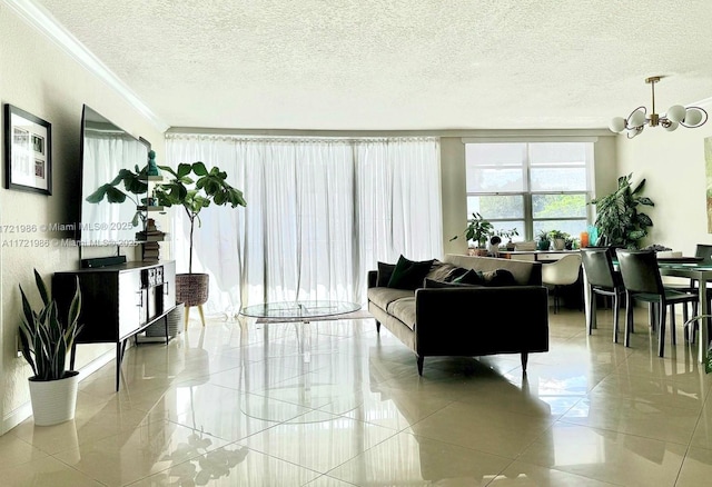 living room with a chandelier, a textured ceiling, and ornamental molding