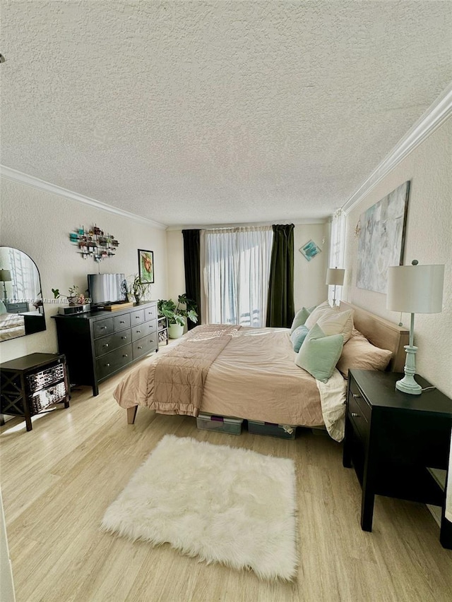 bedroom featuring a textured ceiling, multiple windows, and crown molding