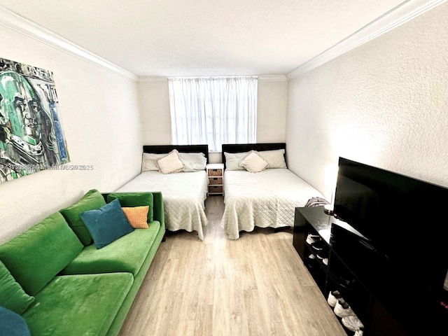 bedroom featuring wood-type flooring and crown molding