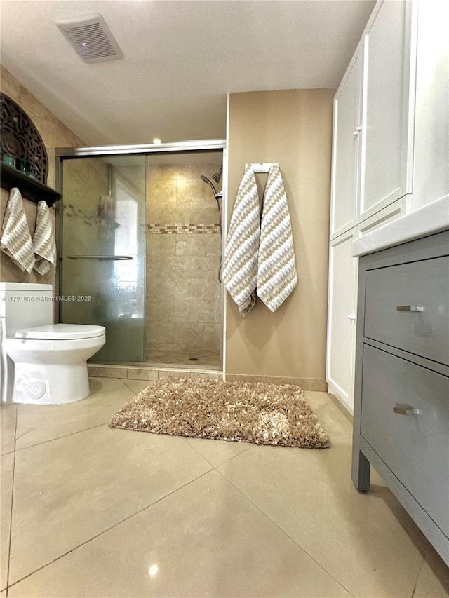 bathroom featuring tile patterned floors, toilet, and walk in shower