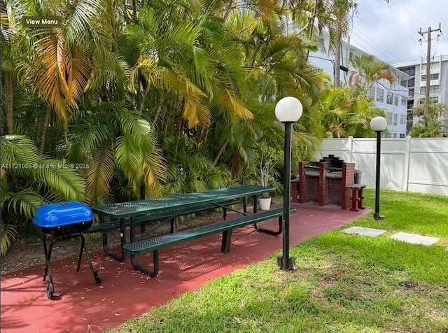 view of community featuring a lawn and exterior bar