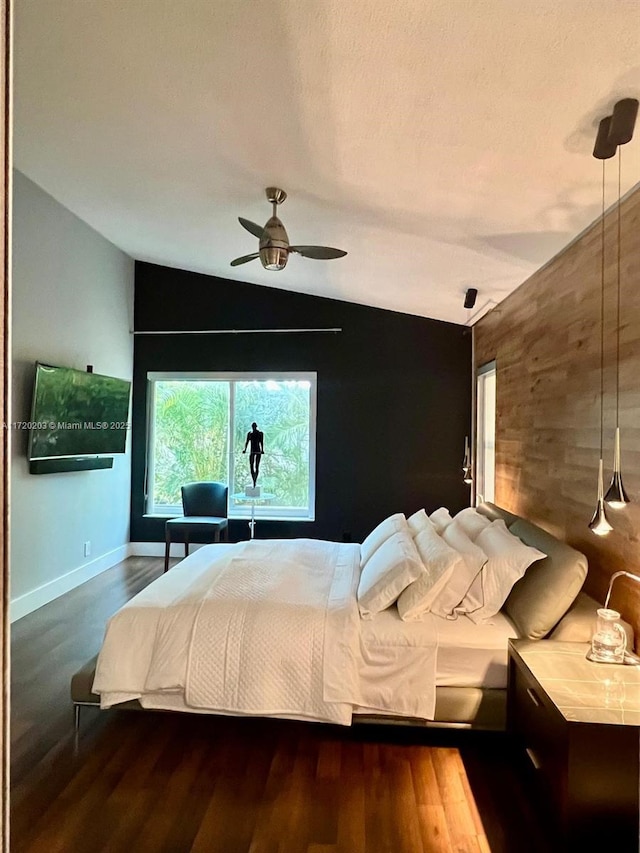 bedroom featuring vaulted ceiling, ceiling fan, and dark hardwood / wood-style floors