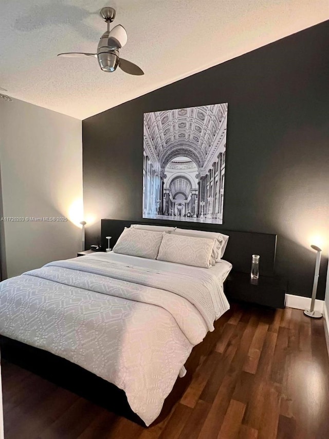 bedroom featuring ceiling fan and dark wood-type flooring