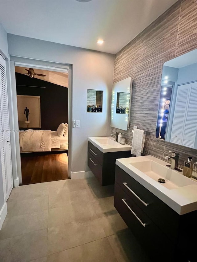 bathroom with ceiling fan, backsplash, and vanity