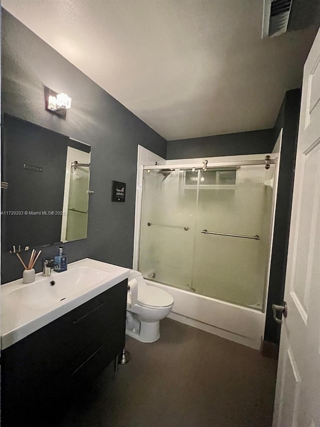 full bathroom featuring shower / bath combination with glass door, vanity, and toilet