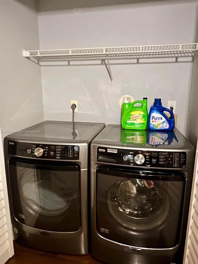 washroom featuring dark hardwood / wood-style floors and washing machine and dryer