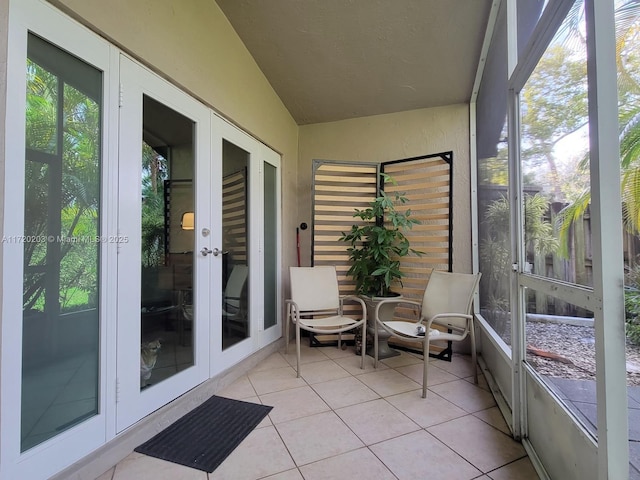 sunroom with lofted ceiling and french doors