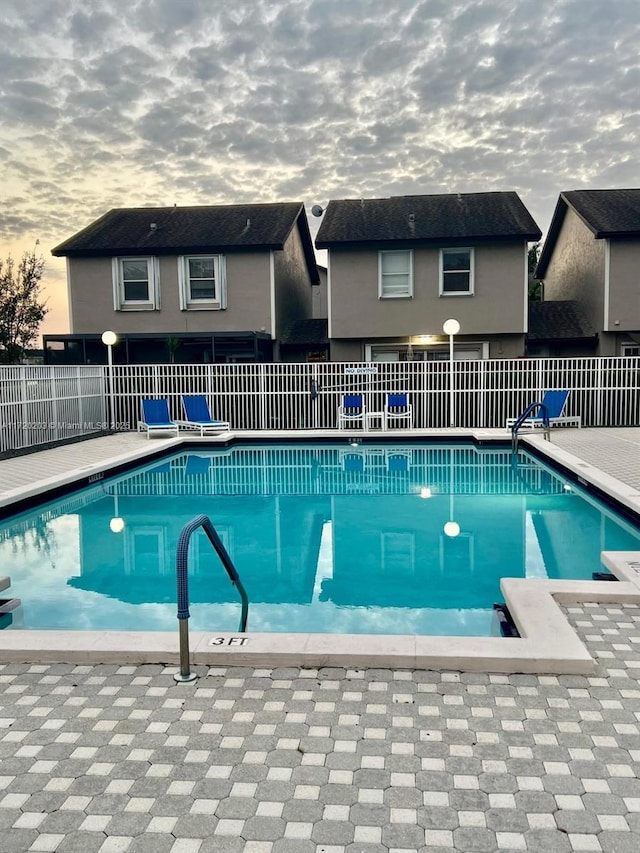 view of pool at dusk