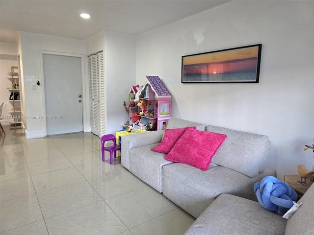 tiled living area featuring recessed lighting