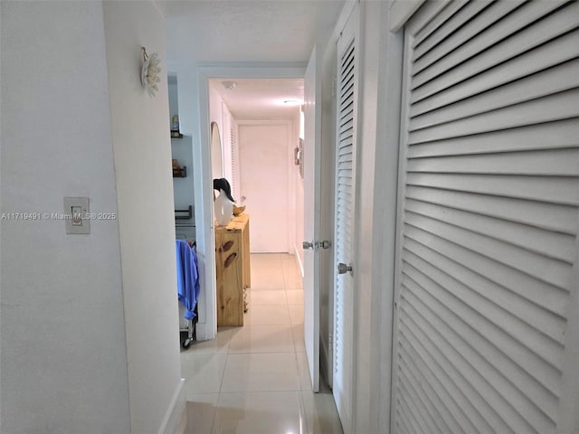 hall with light tile patterned floors