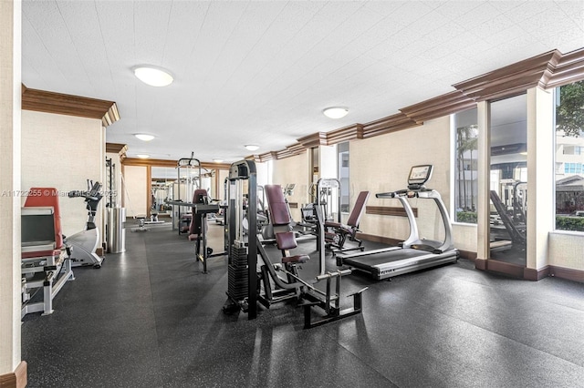 gym featuring plenty of natural light and ornamental molding