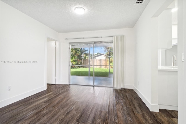 2638 NW 98th Way, Coral Springs, FL 33065 - empty room with wood finished floors, baseboards, a textured ceiling, and a sink