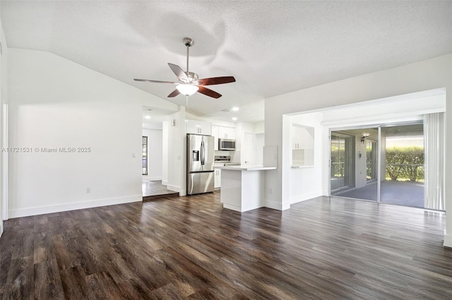 unfurnished living room with a textured ceiling, ceiling fan, dark hardwood / wood-style flooring, and lofted ceiling