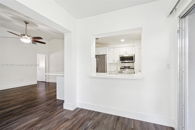 interior space with ceiling fan, sink, dark wood-type flooring, and lofted ceiling