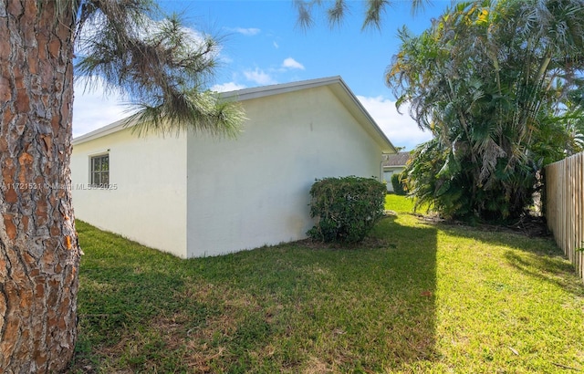 view of property exterior with a lawn