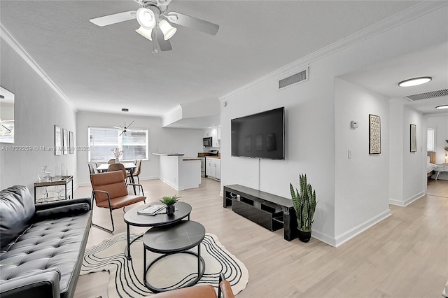 living room with crown molding, ceiling fan, light hardwood / wood-style floors, and a textured ceiling