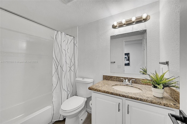 full bathroom with shower / bath combo with shower curtain, vanity, toilet, and a textured ceiling